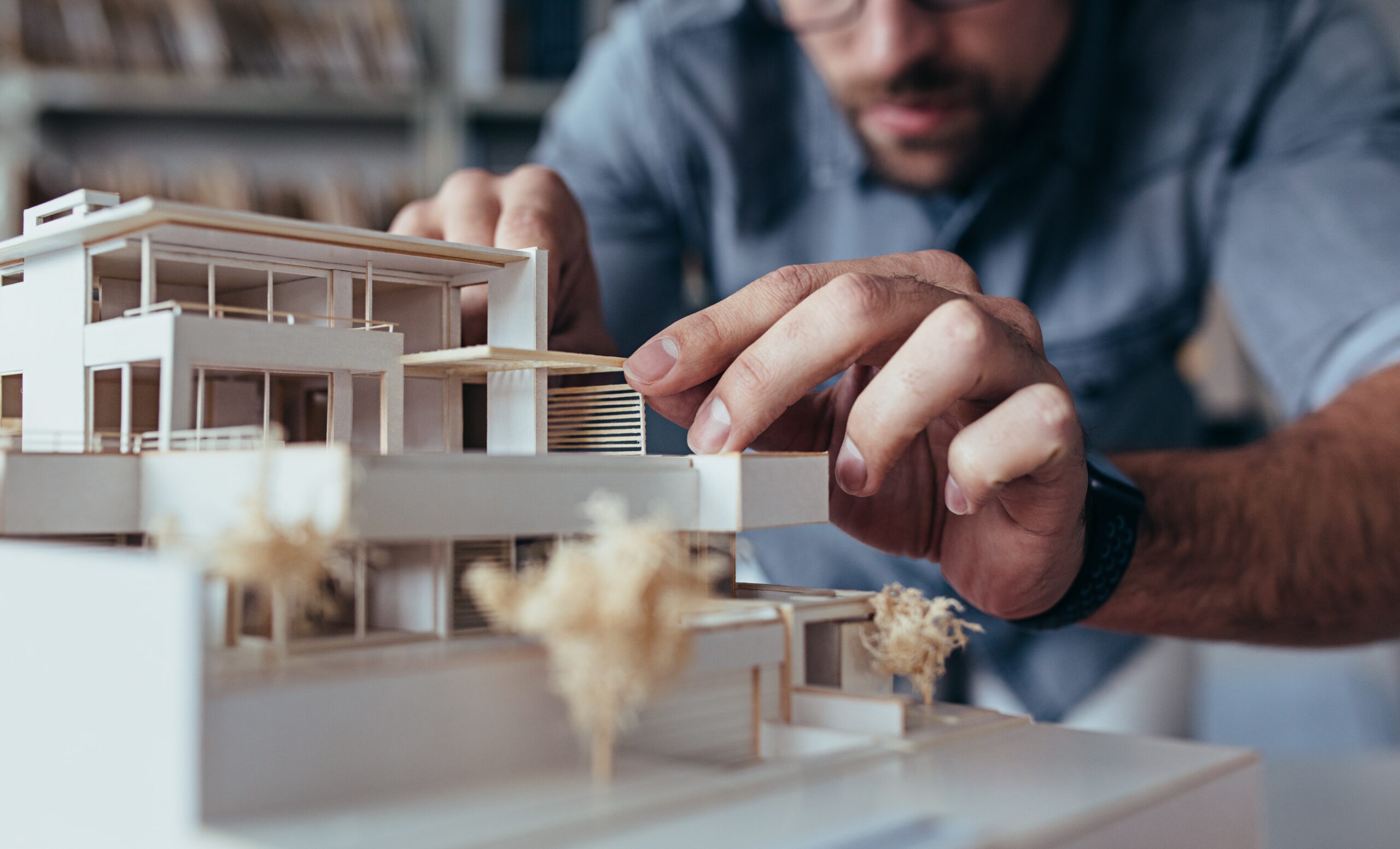 Community Revitalization Going Beyond the Design Bid Build - pic of man building architectural model